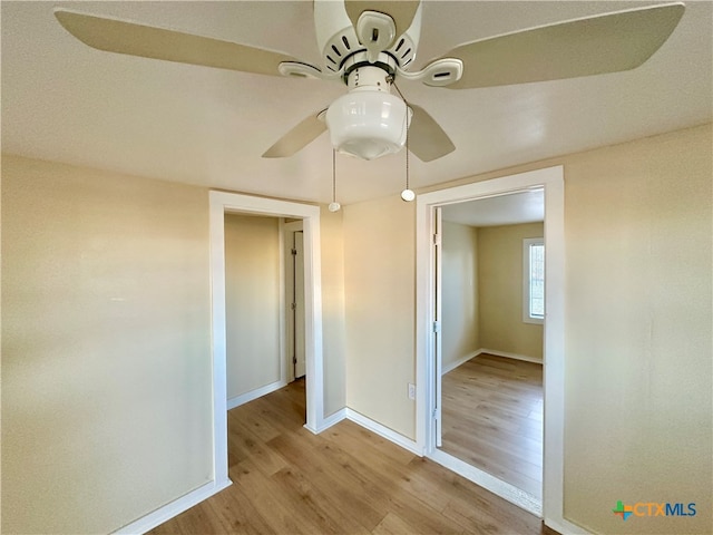 unfurnished bedroom with ceiling fan and light wood-type flooring