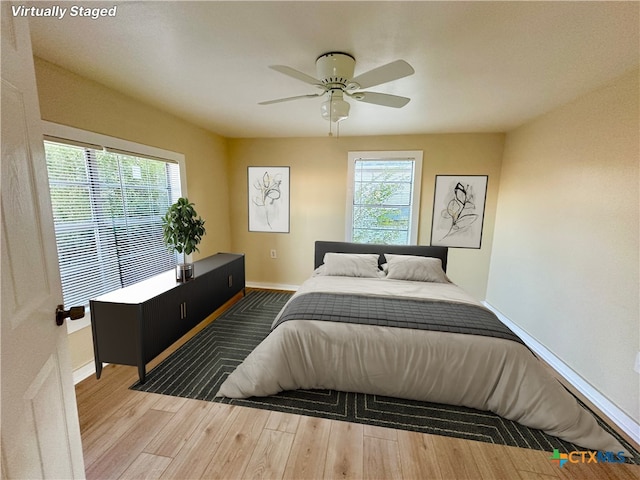 bedroom with hardwood / wood-style floors and ceiling fan