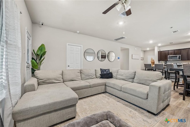 8919 Cantera Ridge Rd, Temple, TX 76502 - living room with light wood finished floors, a ceiling fan, and recessed lighting