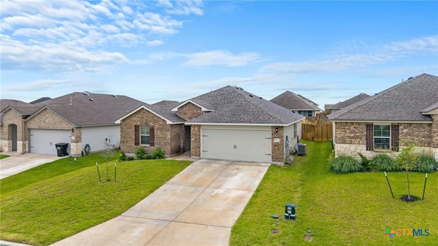 8919 Cantera Ridge Rd, Temple, TX 76502 - view of front facade featuring driveway, an attached garage, brick siding, and roof with shingles