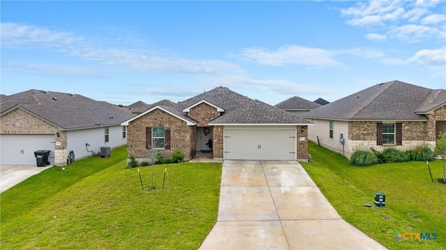 8919 Cantera Ridge Rd, Temple, TX 76502 - view of front of home featuring concrete driveway, a garage, brick siding, and a front lawn