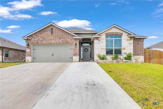 view of front of house with a garage and a front yard