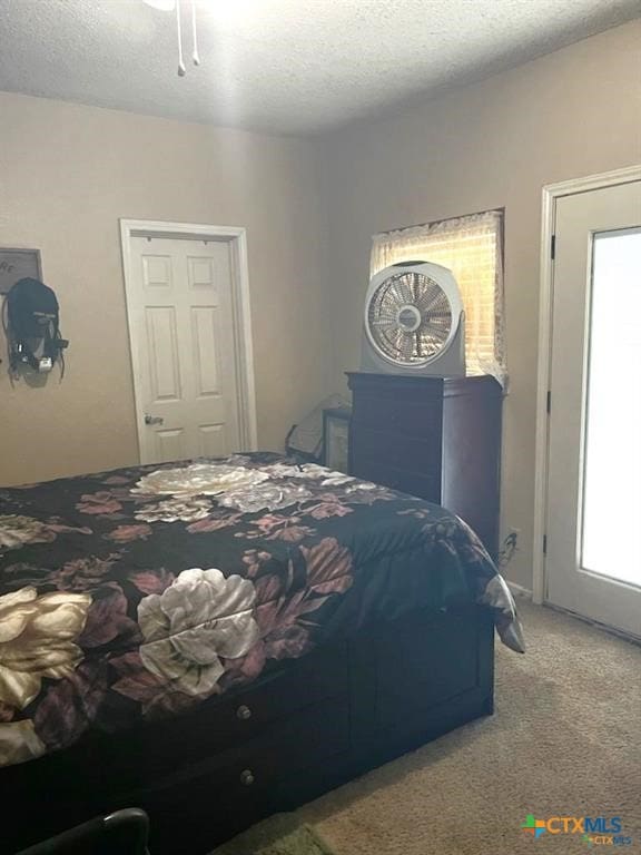 carpeted bedroom featuring a textured ceiling