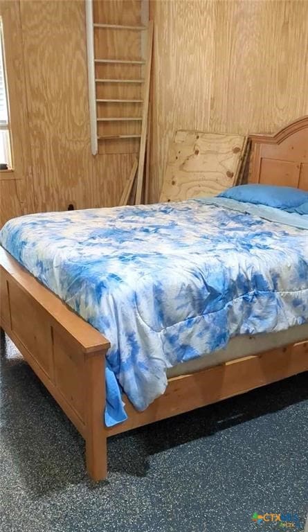 bedroom with wooden walls