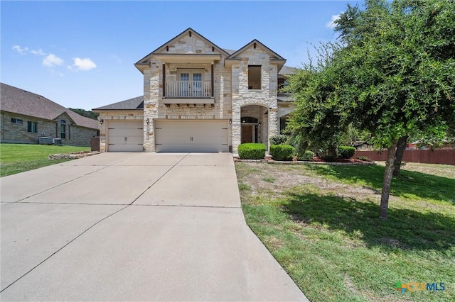 3903 Scenic Trail Dr, Harker Heights, TX 76548 - french country style house featuring stone siding, a balcony, concrete driveway, and an attached garage