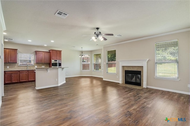 3903 Scenic Trail Dr, Harker Heights, TX 76548 - unfurnished living room with ceiling fan, plenty of natural light, dark wood-style floors, recessed lighting, and crown molding