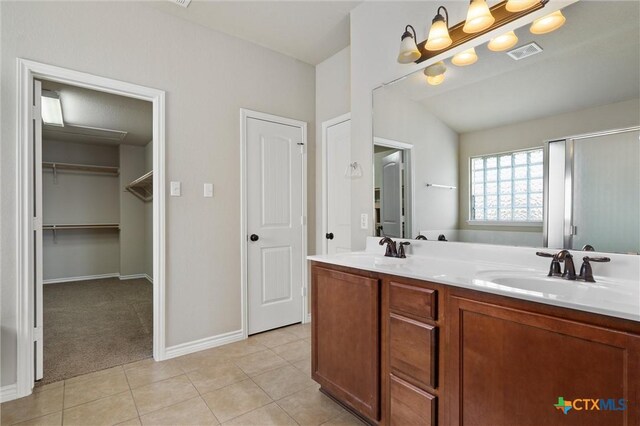 3903 Scenic Trail Dr, Harker Heights, TX 76548 - bathroom with double vanity, tile patterned flooring, baseboards, a stall shower, and a spacious closet