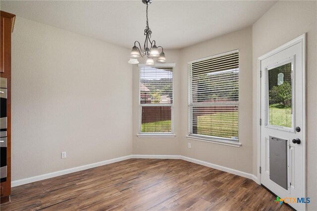 3903 Scenic Trail Dr, Harker Heights, TX 76548 - unfurnished dining area featuring wood finished floors, a chandelier, and baseboards