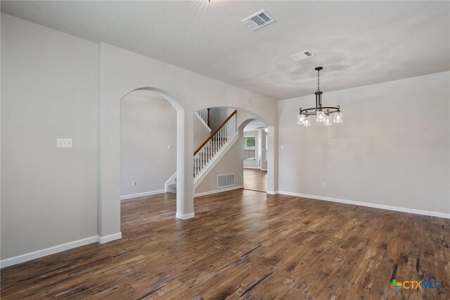 3903 Scenic Trail Dr, Harker Heights, TX 76548 - spare room featuring arched walkways, a chandelier, wood finished floors, stairs, and baseboards