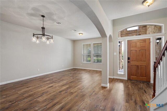 3903 Scenic Trail Dr, Harker Heights, TX 76548 - foyer featuring a chandelier, baseboards, dark wood-style flooring, arched walkways, and stairway