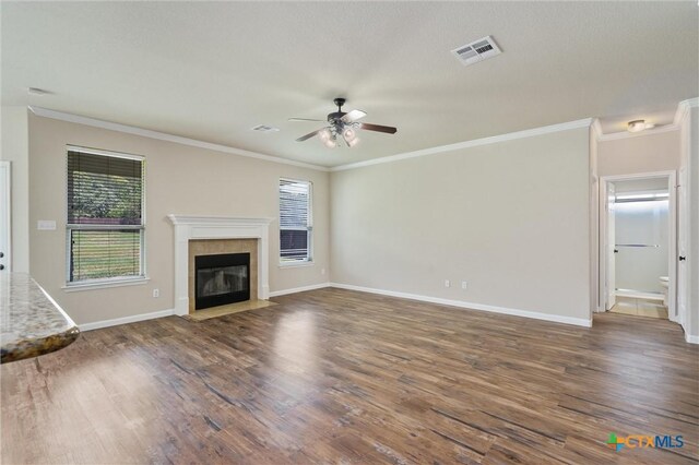 3903 Scenic Trail Dr, Harker Heights, TX 76548 - unfurnished living room with a ceiling fan, wood finished floors, ornamental molding, baseboards, and a tile fireplace