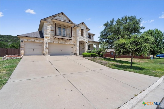 3903 Scenic Trail Dr, Harker Heights, TX 76548 - french country home with stone siding, a balcony, driveway, and an attached garage