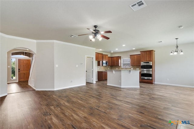 3903 Scenic Trail Dr, Harker Heights, TX 76548 - unfurnished living room with arched walkways, ceiling fan, a chandelier, dark wood finished floors, and recessed lighting