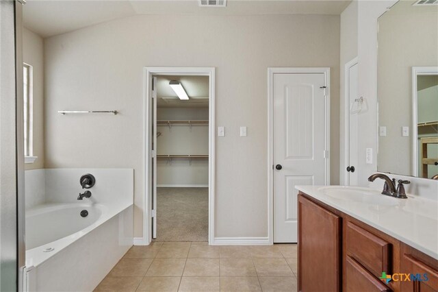 3903 Scenic Trail Dr, Harker Heights, TX 76548 - full bath featuring a bath, vanity, tile patterned flooring, baseboards, and vaulted ceiling