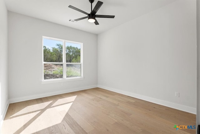 spare room with light hardwood / wood-style floors and ceiling fan