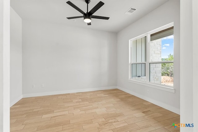 empty room with ceiling fan and light wood-type flooring