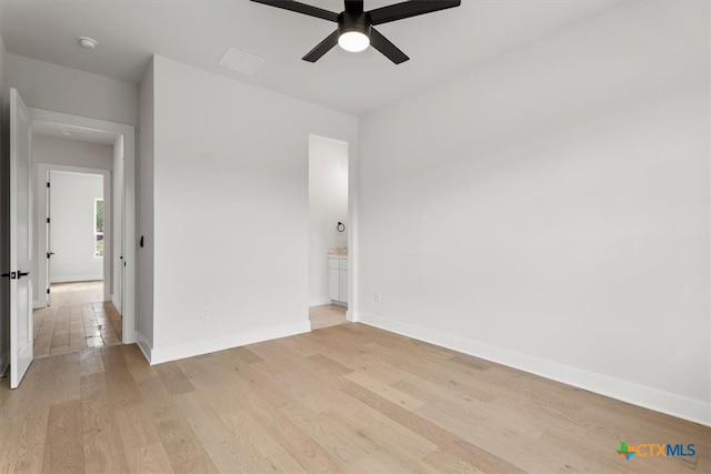 unfurnished room with light wood-type flooring and ceiling fan