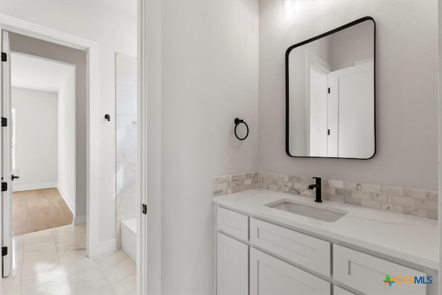 bathroom with hardwood / wood-style floors, vanity, and shower / bathtub combination