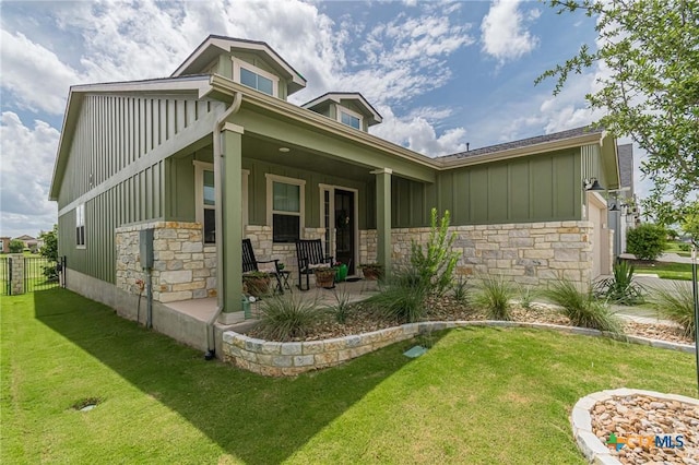 1308 Dancing Oak Ln, San Marcos, TX 78666 - back of property featuring board and batten siding, stone siding, and a porch