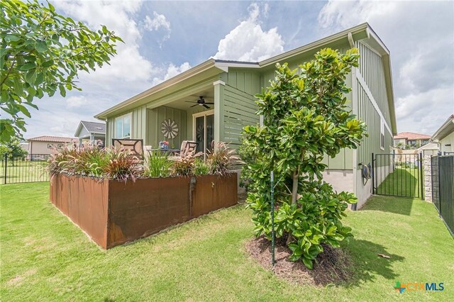 1308 Dancing Oak Ln, San Marcos, TX 78666 - view of side of property featuring a ceiling fan and board and batten siding