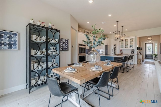 1308 Dancing Oak Ln, San Marcos, TX 78666 - dining room featuring light wood-style flooring, a chandelier, and recessed lighting