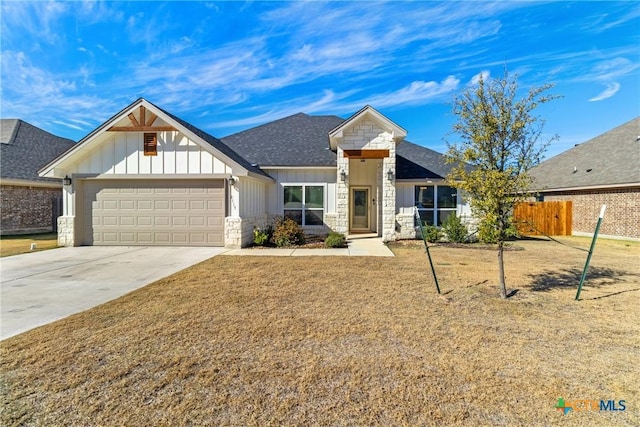 view of front of property featuring a garage and a front yard