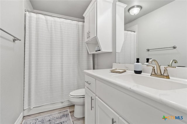 bathroom featuring toilet, walk in shower, and vanity