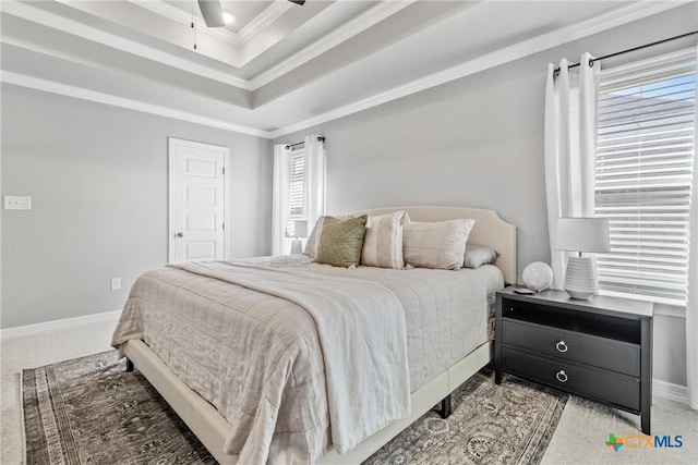 bedroom featuring ceiling fan, light colored carpet, crown molding, and a raised ceiling