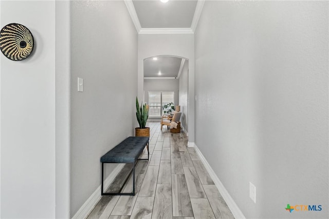 corridor featuring ornamental molding and light wood-type flooring