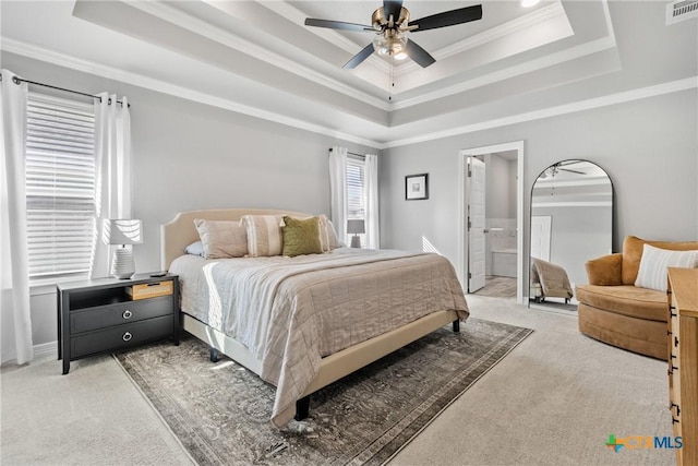 bedroom with ceiling fan, light colored carpet, a tray ceiling, and ornamental molding