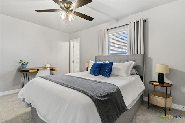 carpeted bedroom with ceiling fan and radiator