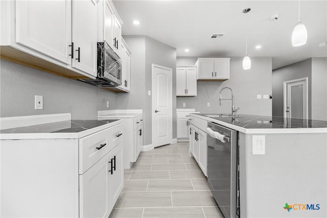 kitchen featuring stainless steel appliances, visible vents, hanging light fixtures, white cabinets, and a sink