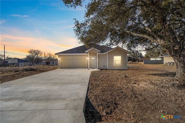 ranch-style home featuring a garage and driveway