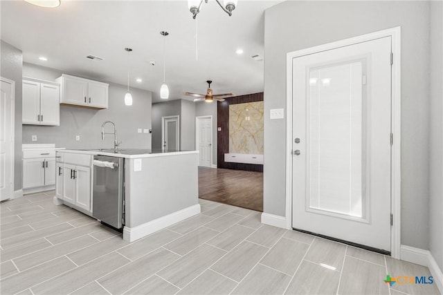 kitchen with a center island with sink, white cabinets, dishwasher, hanging light fixtures, and light countertops