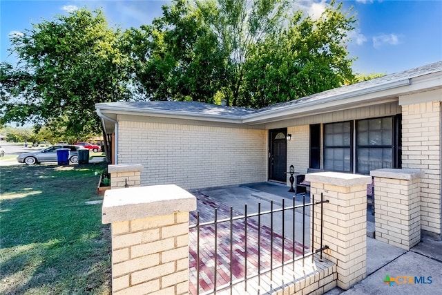 doorway to property with a yard