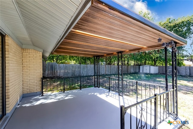 view of patio / terrace featuring a storage unit