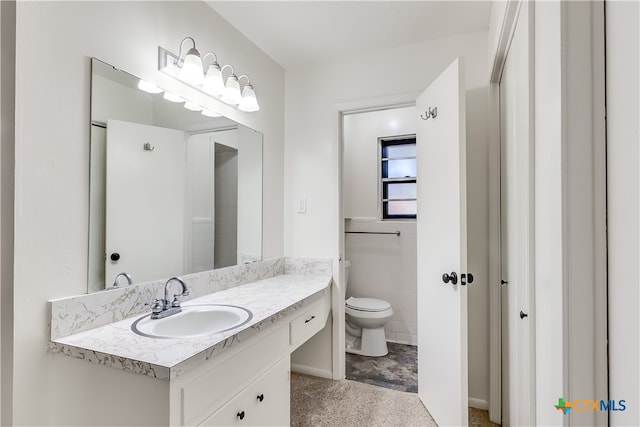 bathroom with tile walls, vanity, and toilet