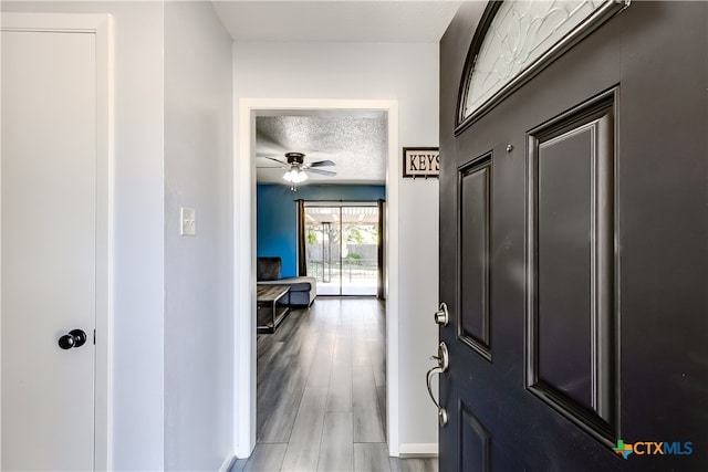 entrance foyer featuring hardwood / wood-style floors, a textured ceiling, and ceiling fan