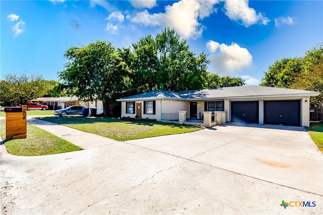 single story home with a garage and a front lawn