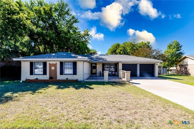 ranch-style home featuring a front lawn and a garage