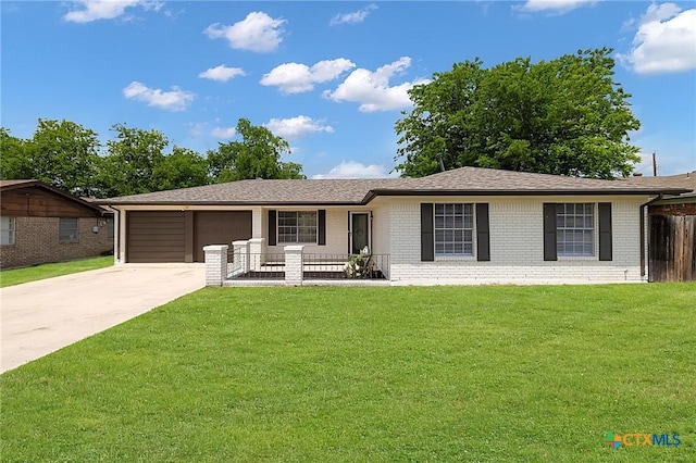 ranch-style house featuring concrete driveway, a garage, brick siding, and a front yard