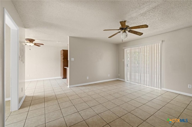 unfurnished room featuring light tile patterned floors, baseboards, ceiling fan, and a textured ceiling