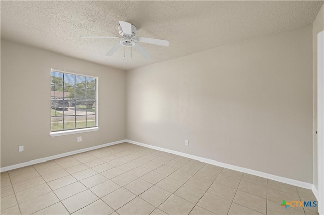 unfurnished room with light tile patterned floors, a textured ceiling, baseboards, and a ceiling fan