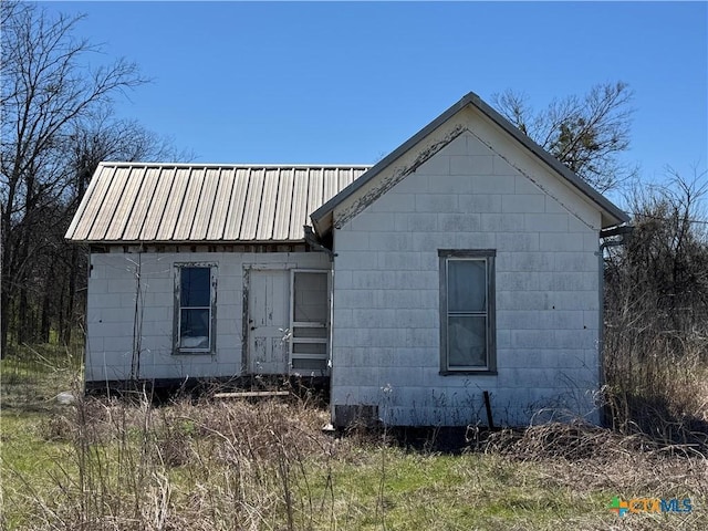 view of side of home with metal roof