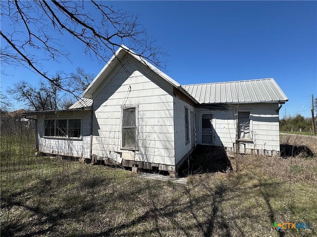 view of property exterior featuring metal roof