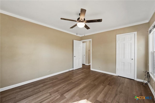 unfurnished bedroom featuring ornamental molding, ceiling fan, and dark wood-type flooring