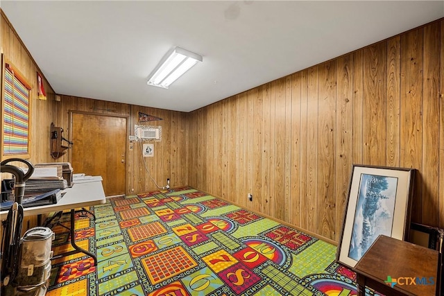 carpeted bedroom with wooden walls