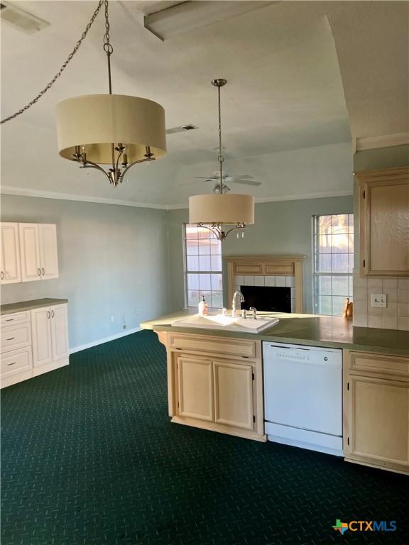 kitchen with pendant lighting, dishwasher, a peninsula, and a sink