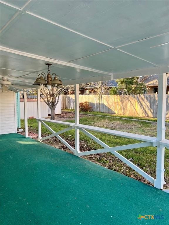 exterior space featuring ceiling fan and fence