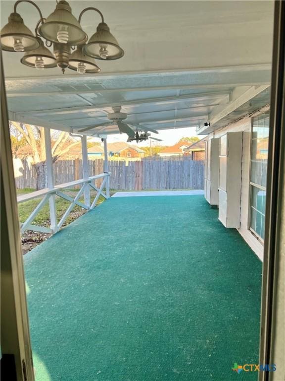 view of patio / terrace with ceiling fan and fence